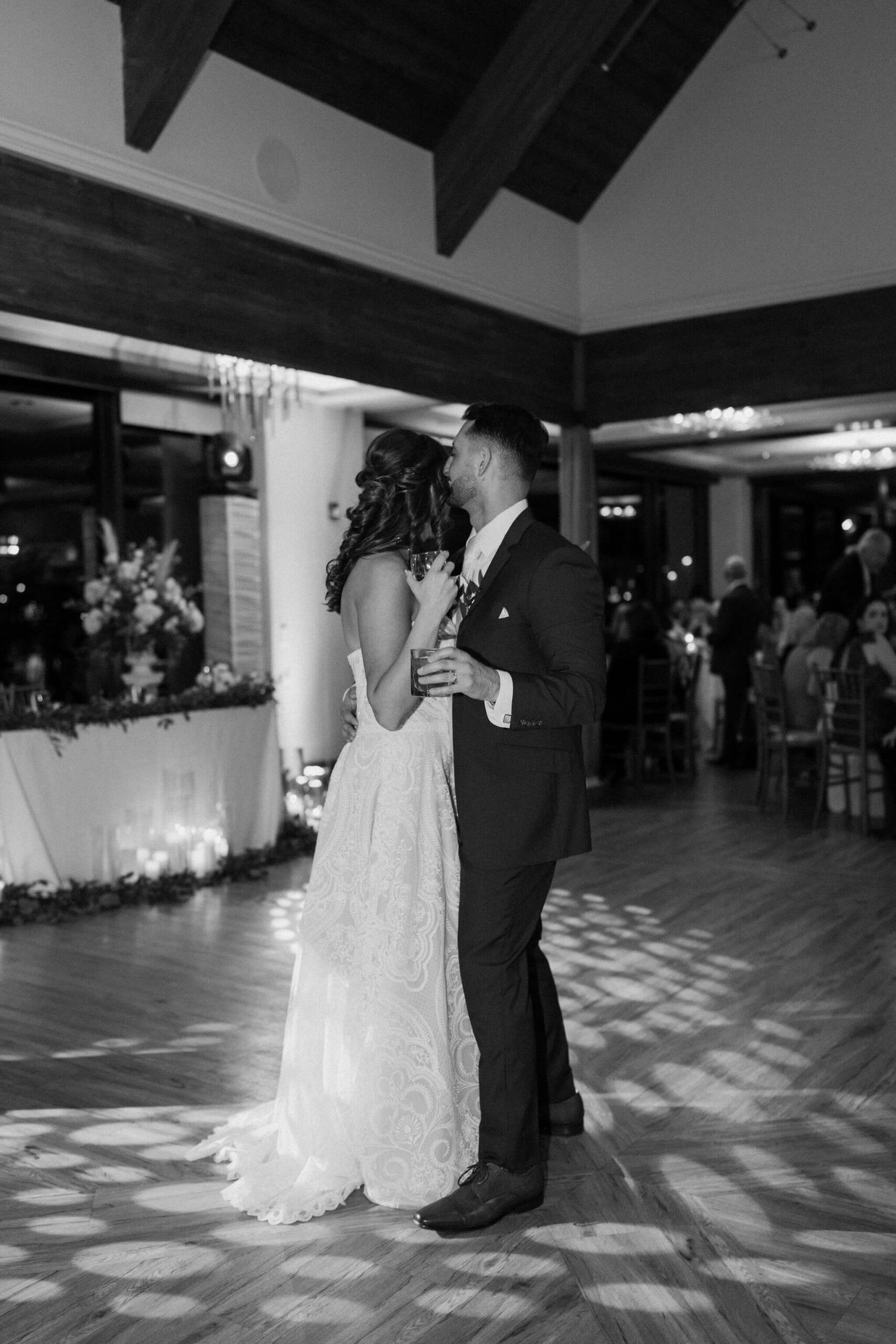 black and white image of a bride and groom embracing on the dance floor in lambertville new jersey