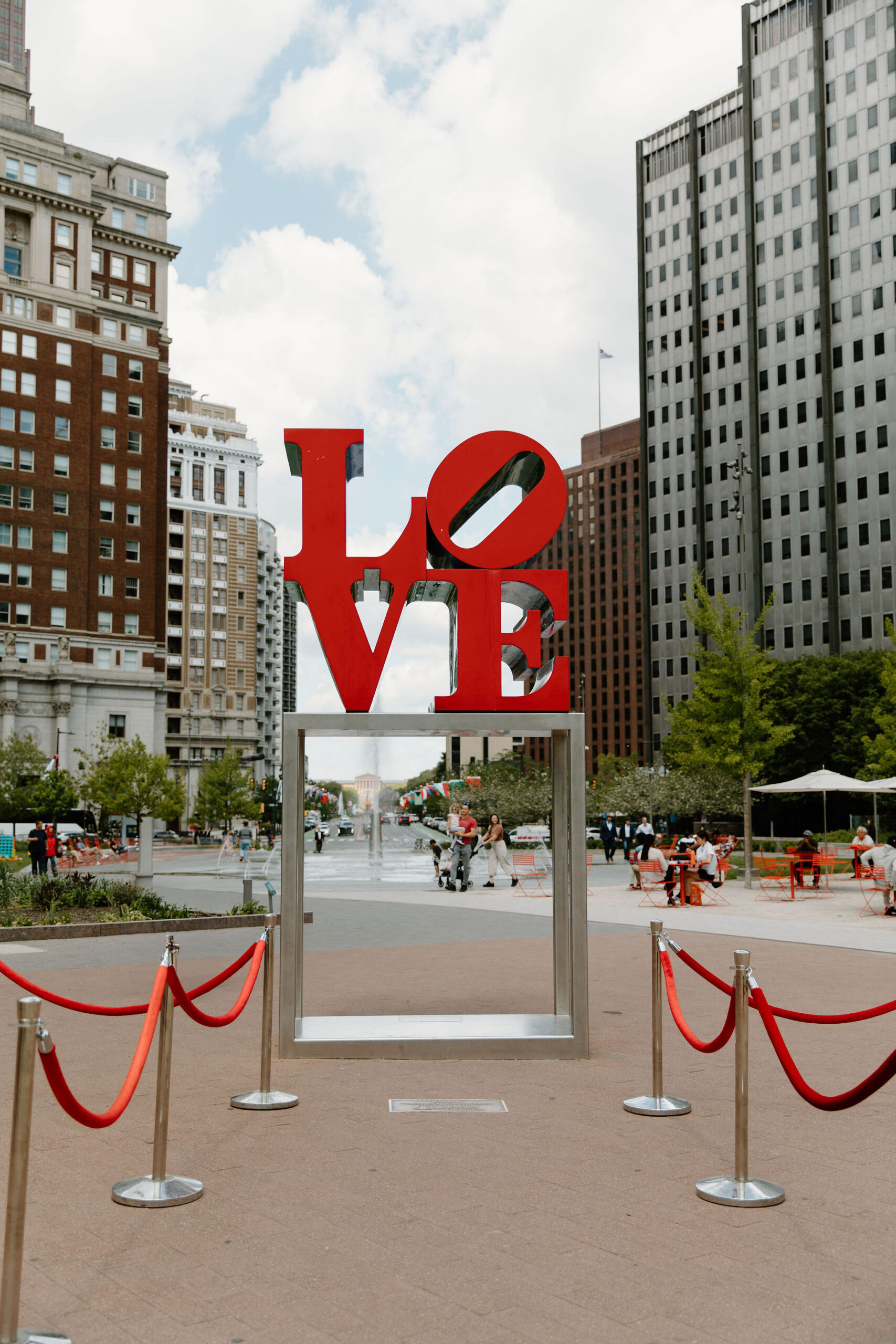 The large red LOVE sign at Love Park, with red velvet roped off aisle for elopement