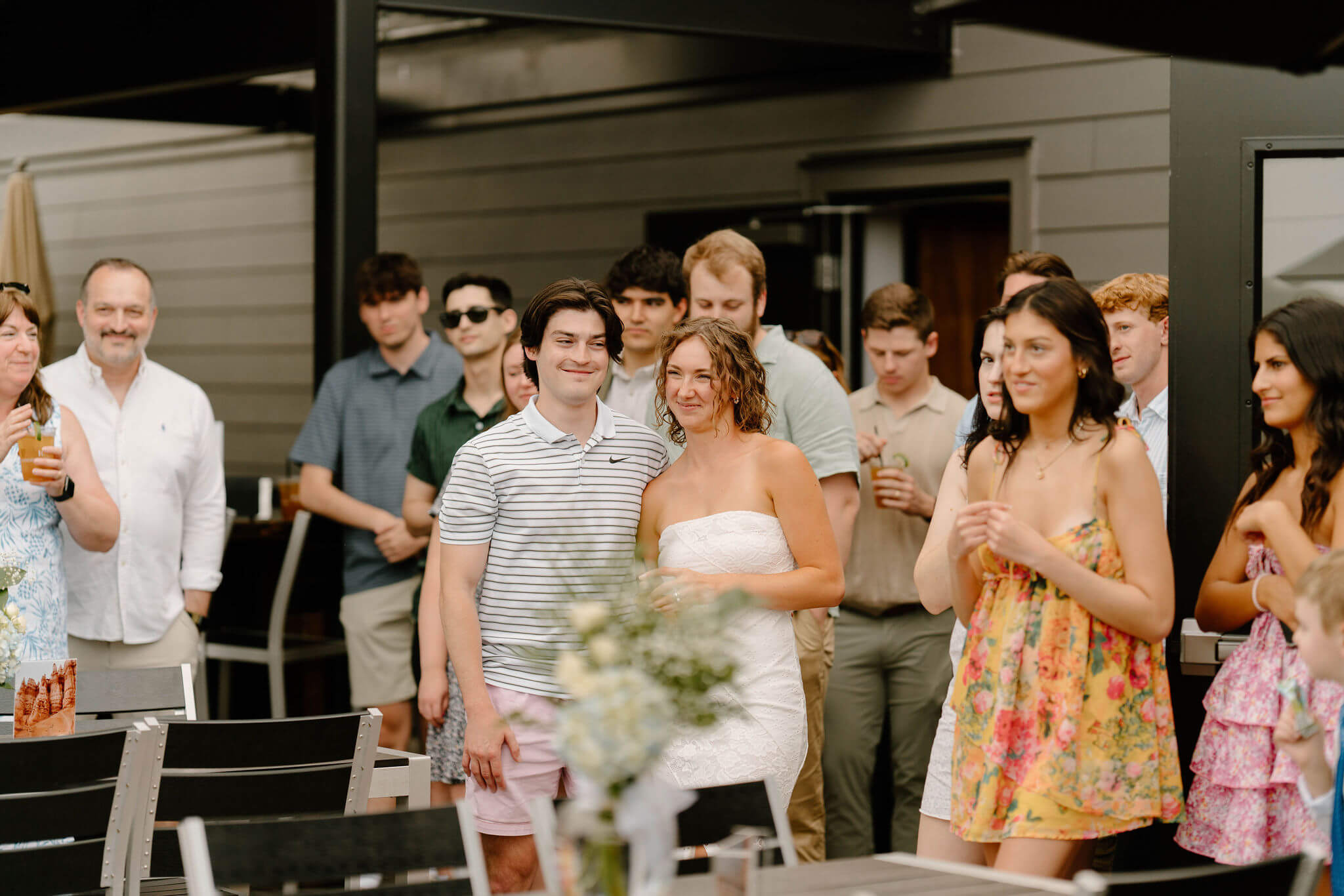 bride and groom smiling amongst guests