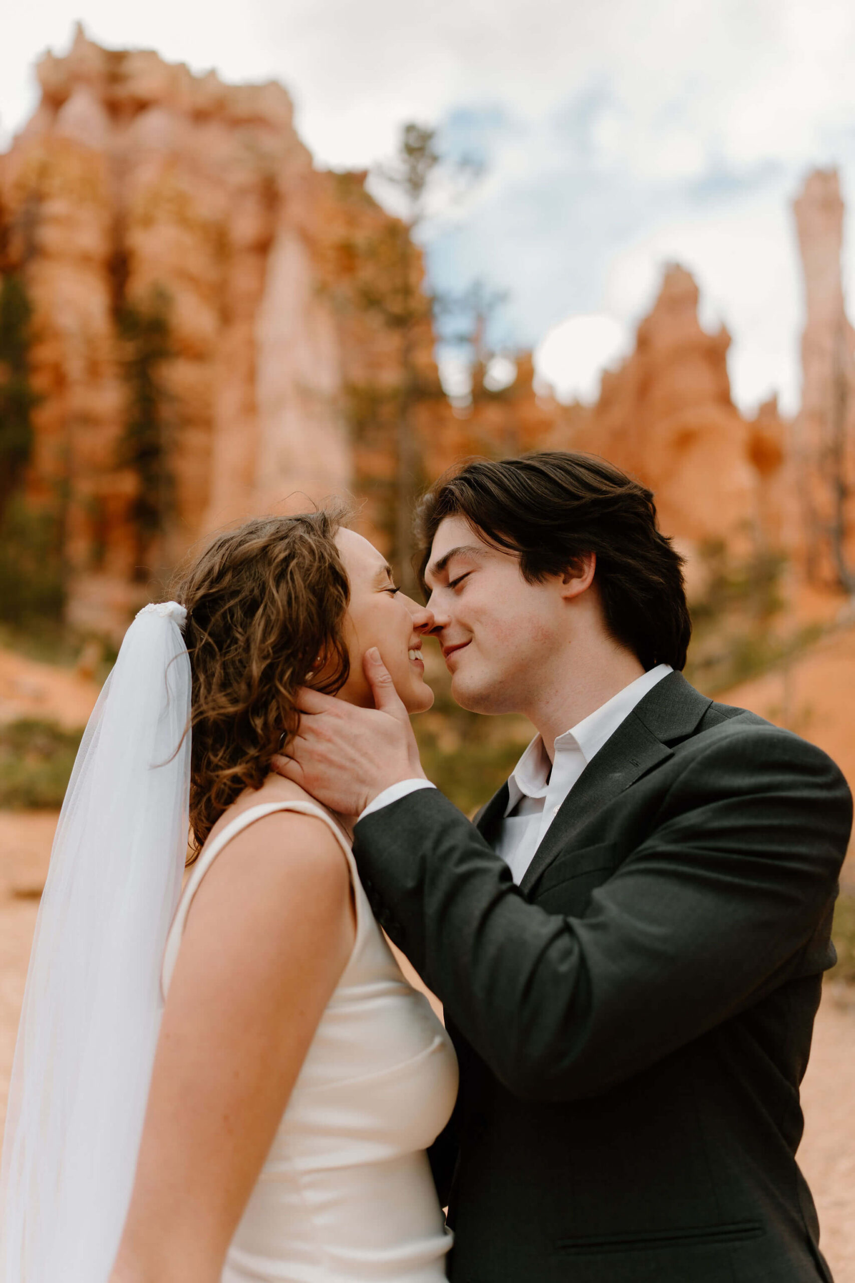 close up of groom holding bride's face, about to kiss her