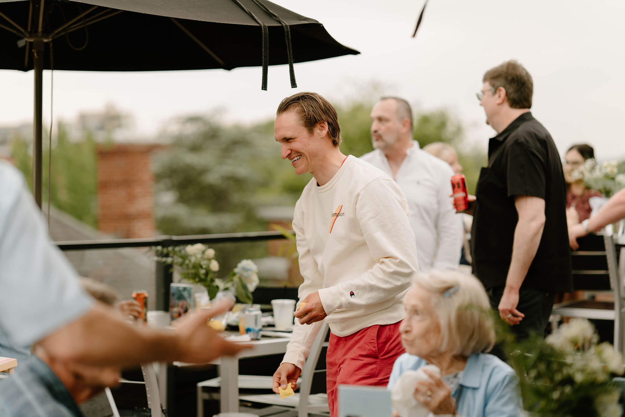 a guest laughing while playing mini-cornhole