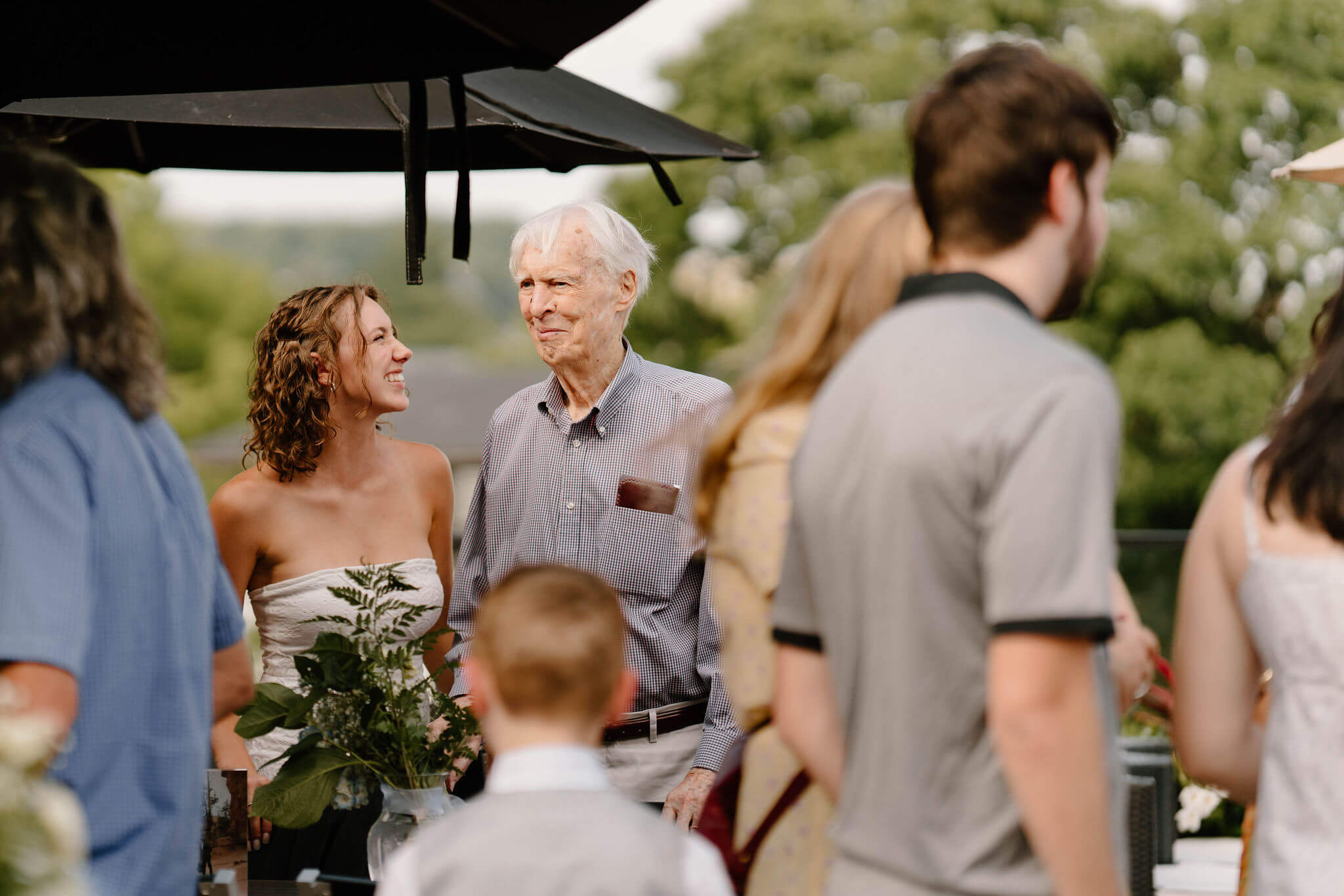 bride smiling at her grandfather at her wedding reception