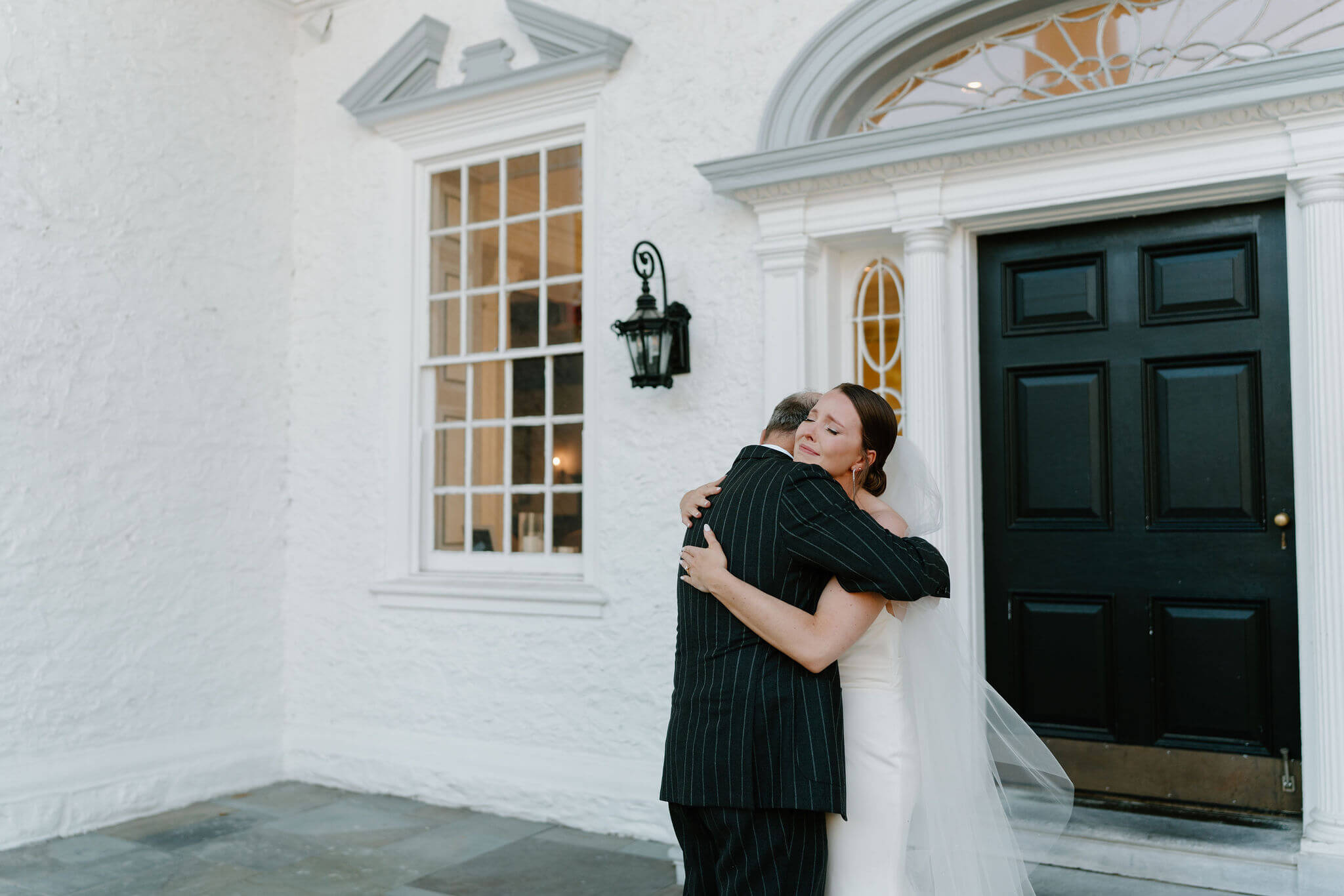 bride embracing her father and crying after their first look