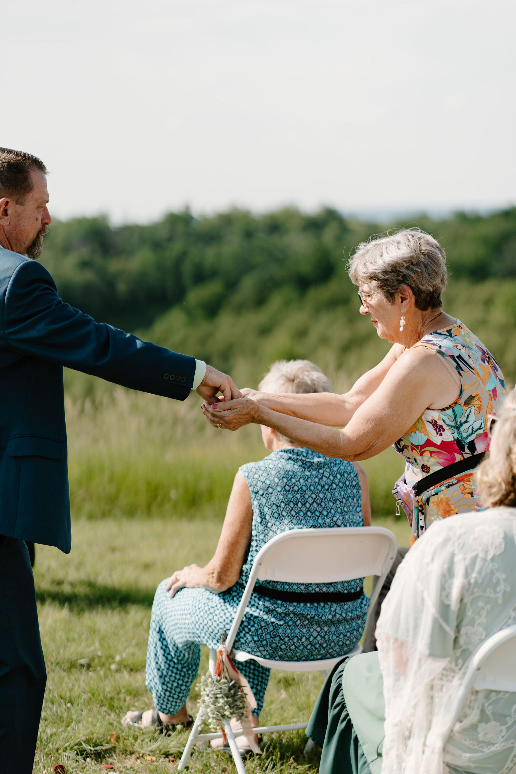 family of the couple passing rings around to each guest in a "ring warming ceremony"