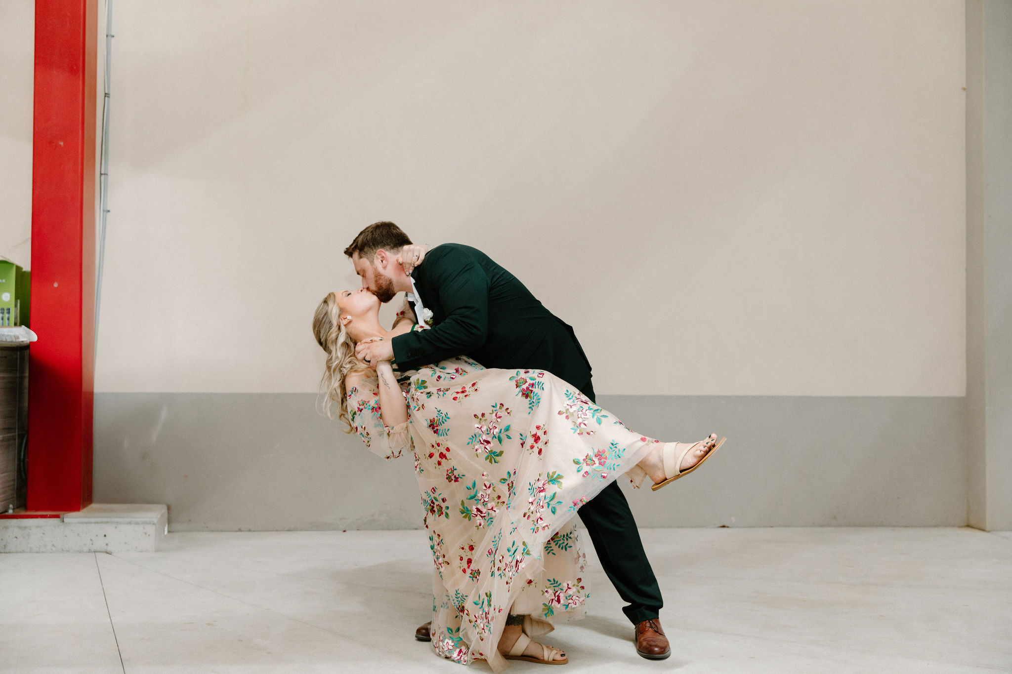 groom dipping bride and kissing her during their first dance