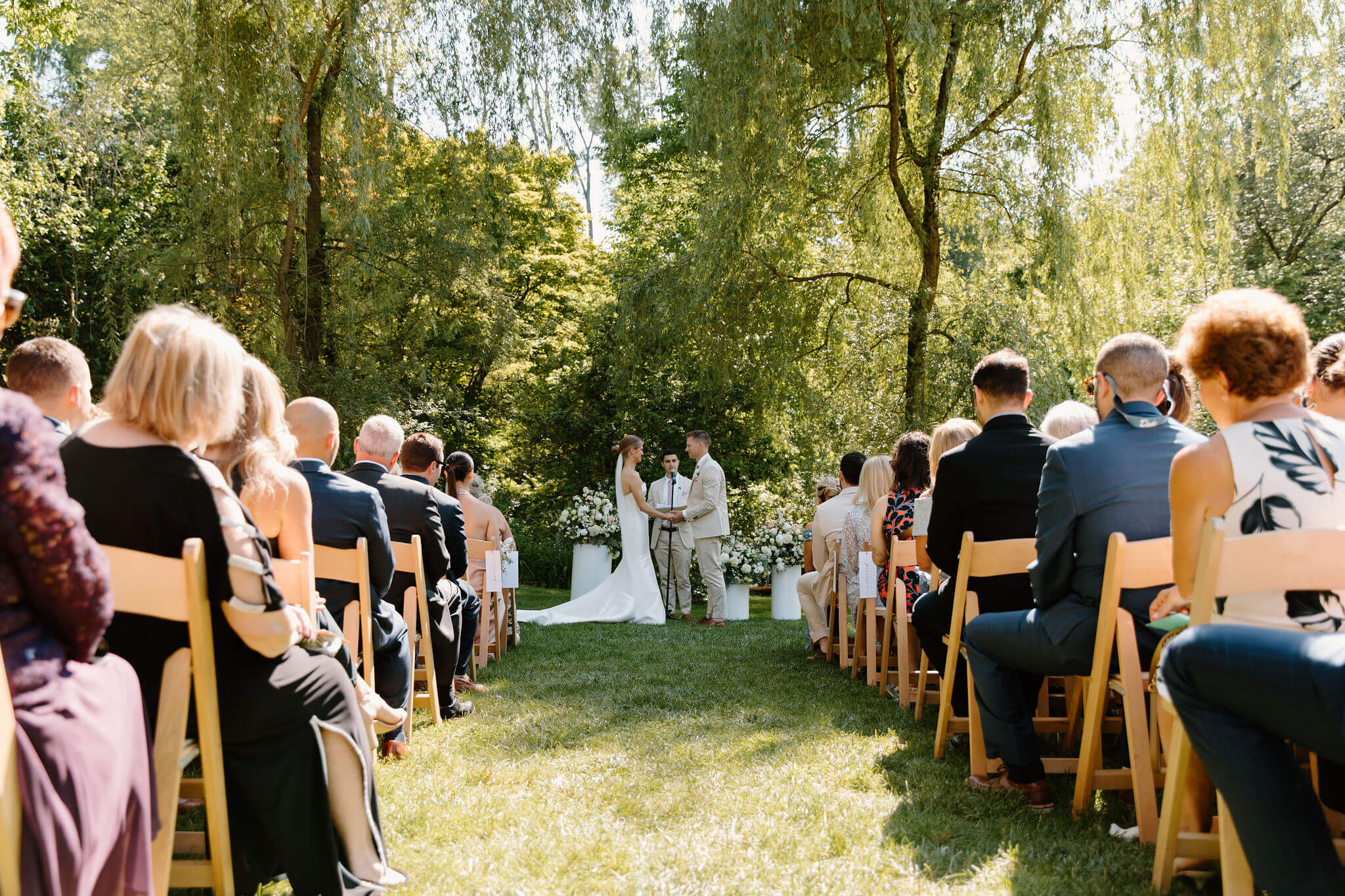 bride and groom holding hands at the altar for their spring wedding ceremony
