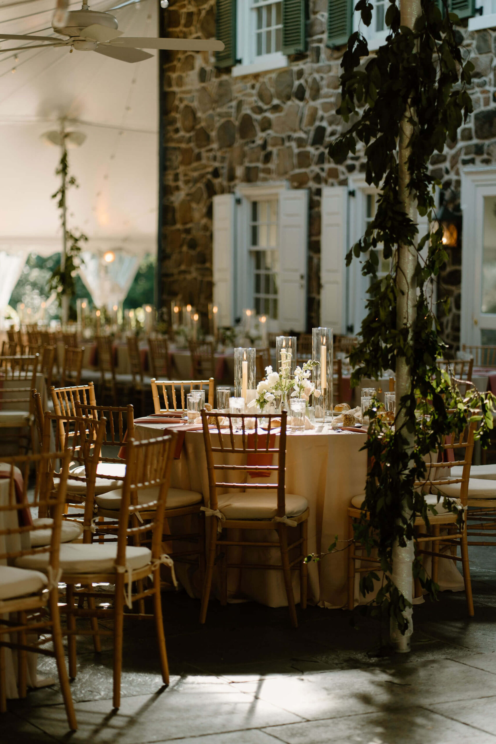round table illuminated by sunlight in the center of wedding reception space
