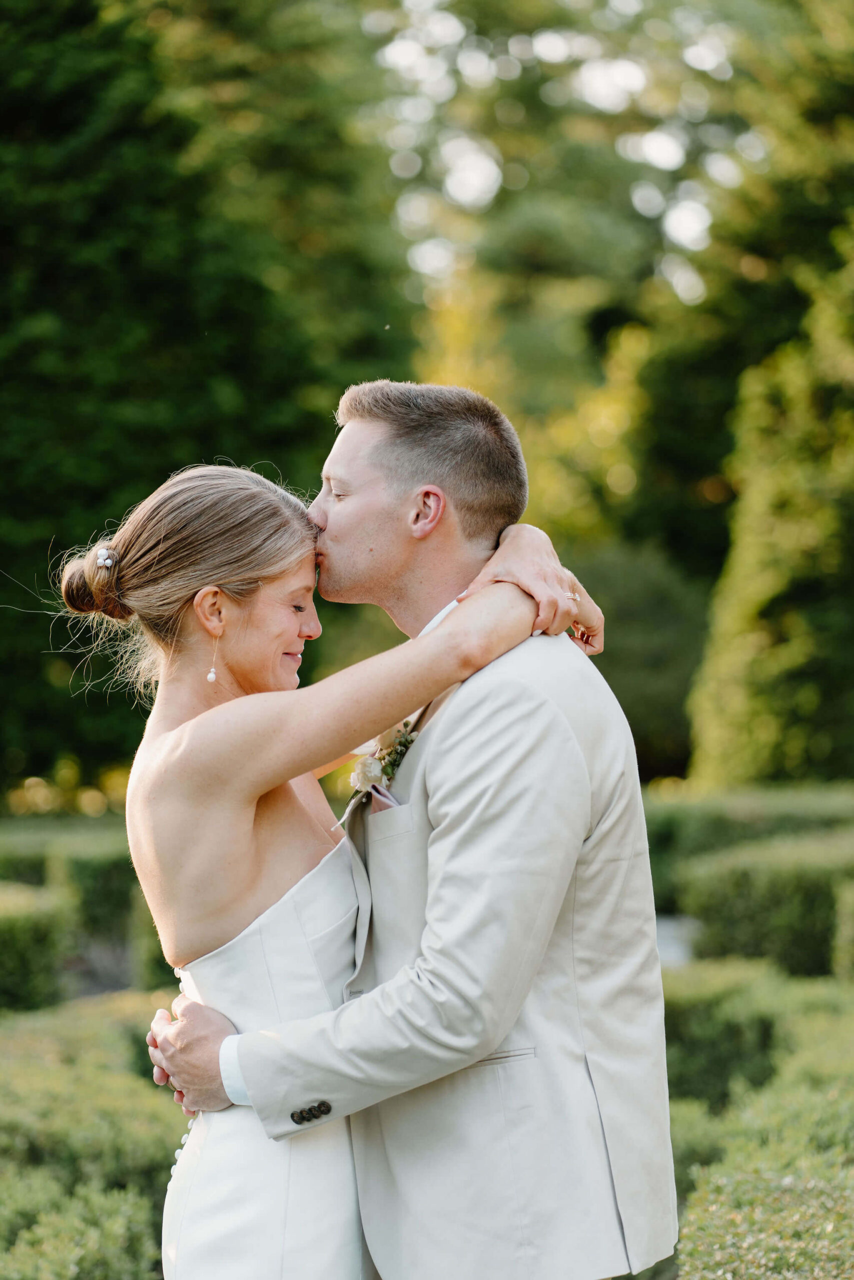 groom kissing his bride on the forehead