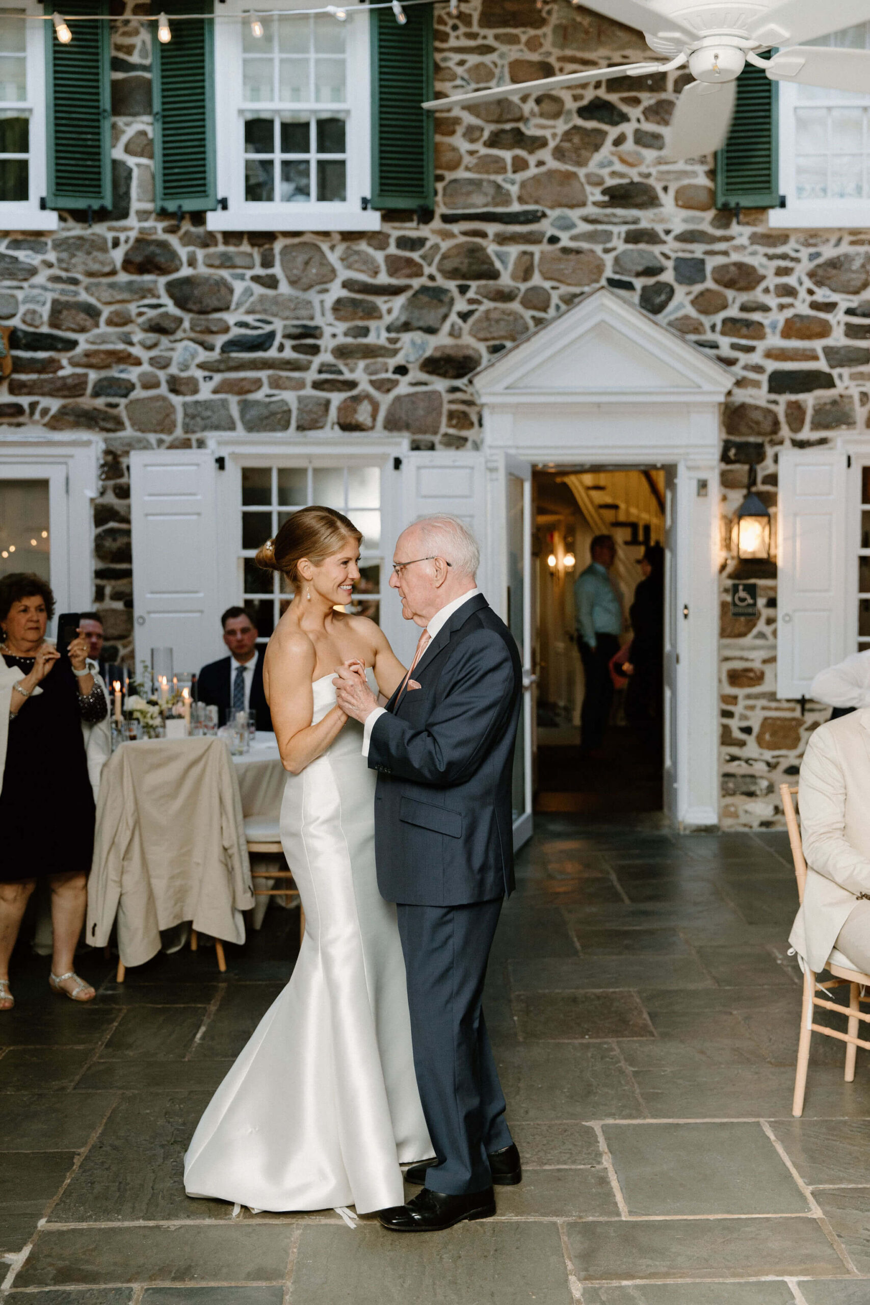 bride having a first dance with her grandfather during wedding reception