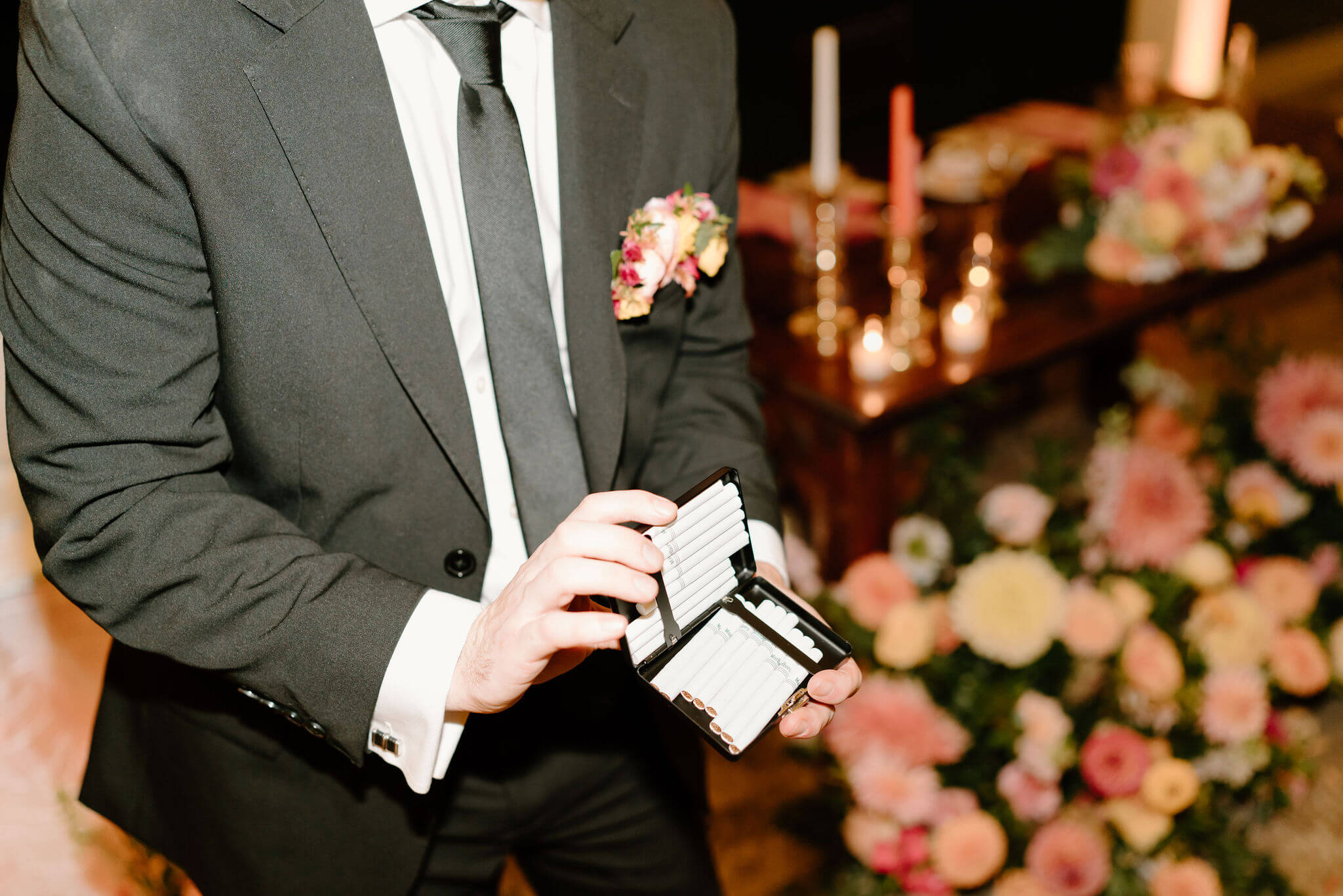groom showing cigarettes in custom cigarette case