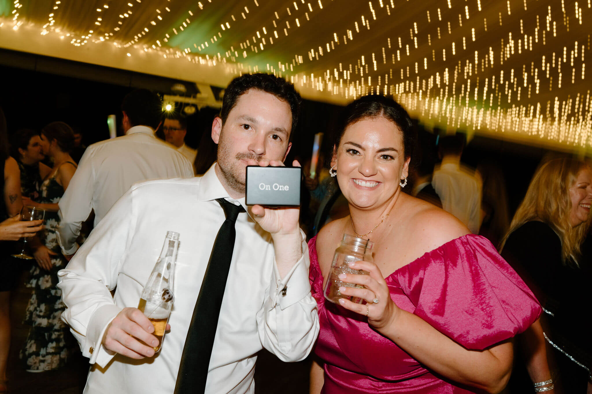 groom and maid of honor showing the camera the custom cigarette case she gifted him