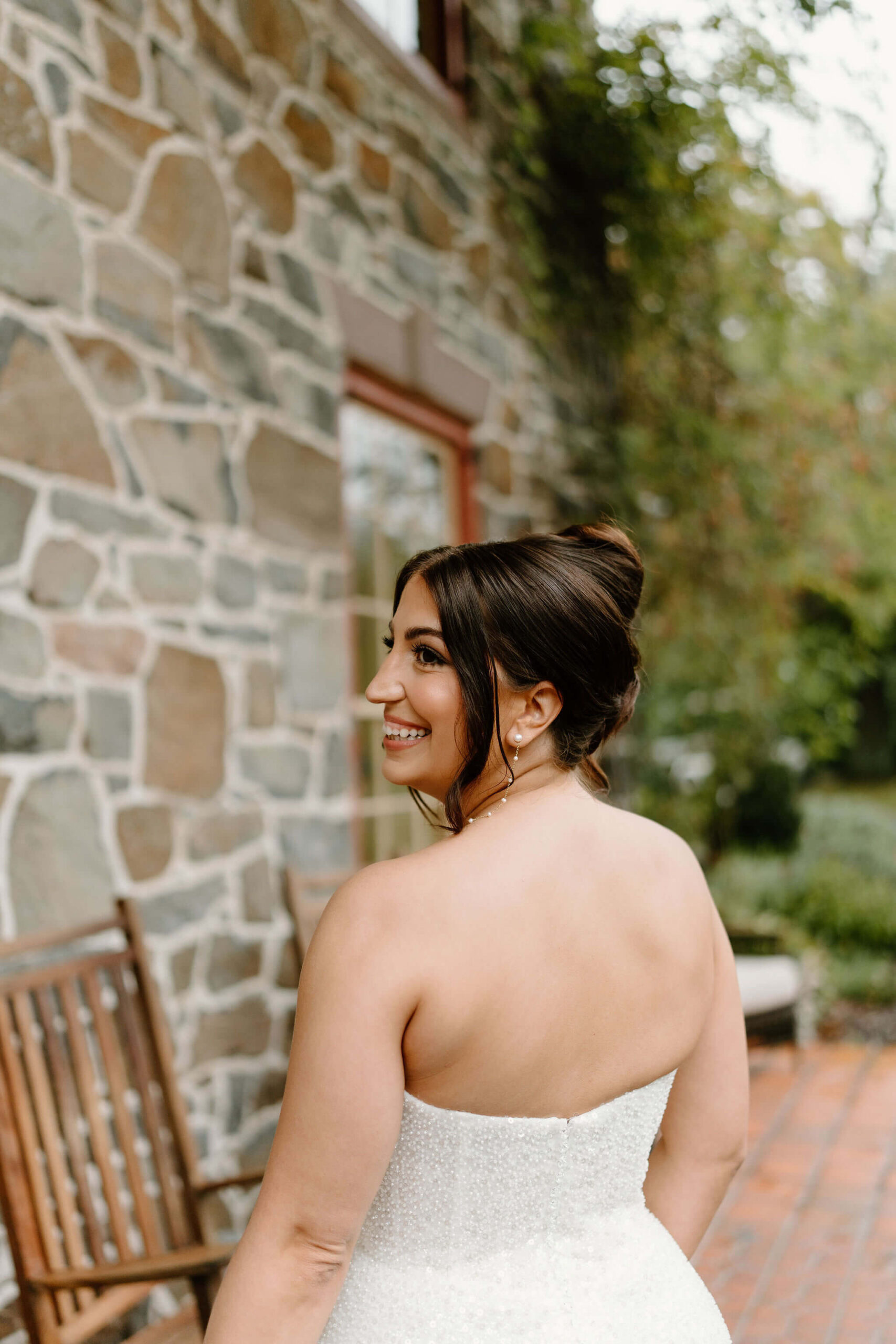 portrait of bride smiling over her shoulder toward the camera