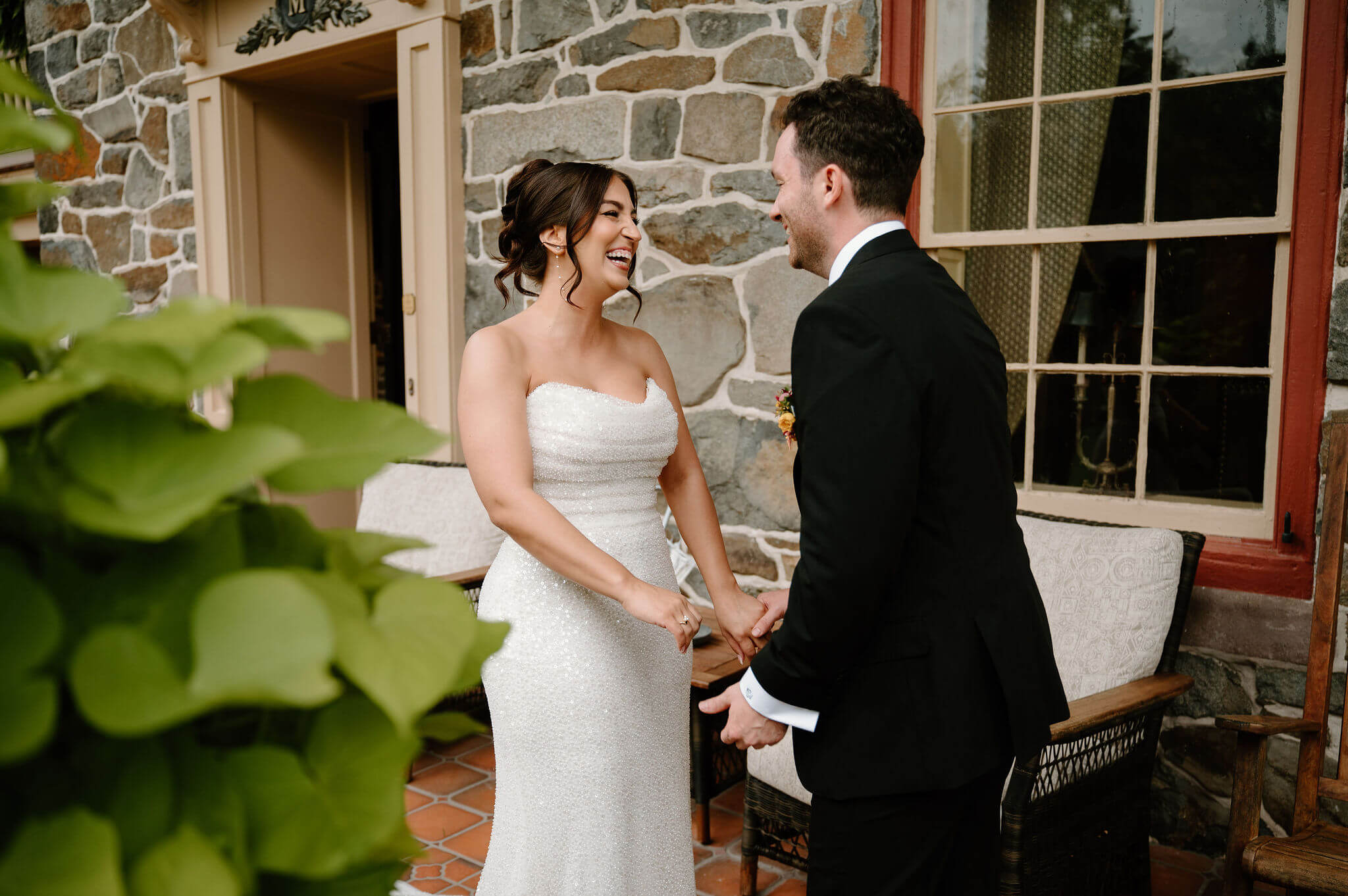bride and groom reaching for each other and laughing after their first look