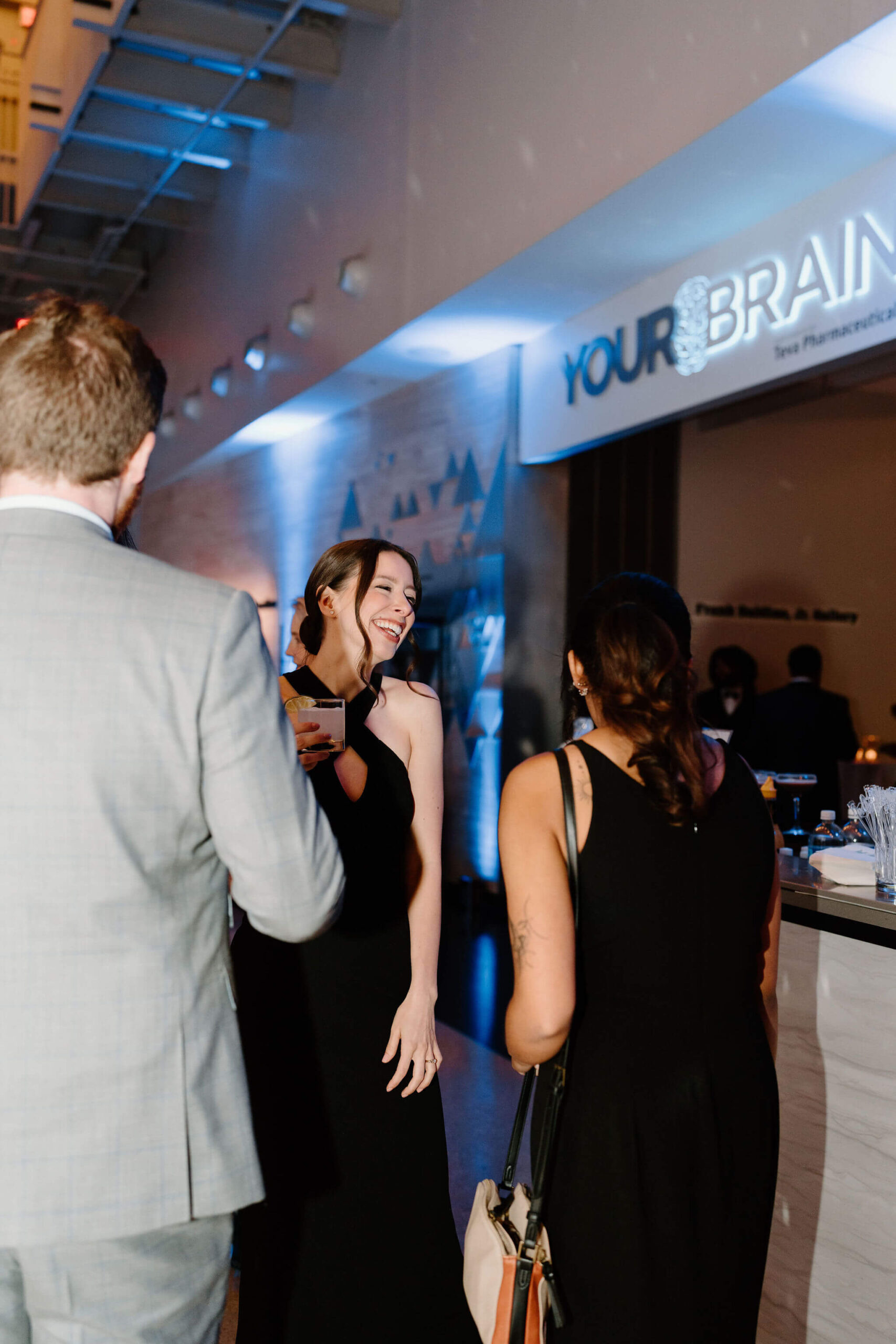 two wedding guests laughing and smiling at each other