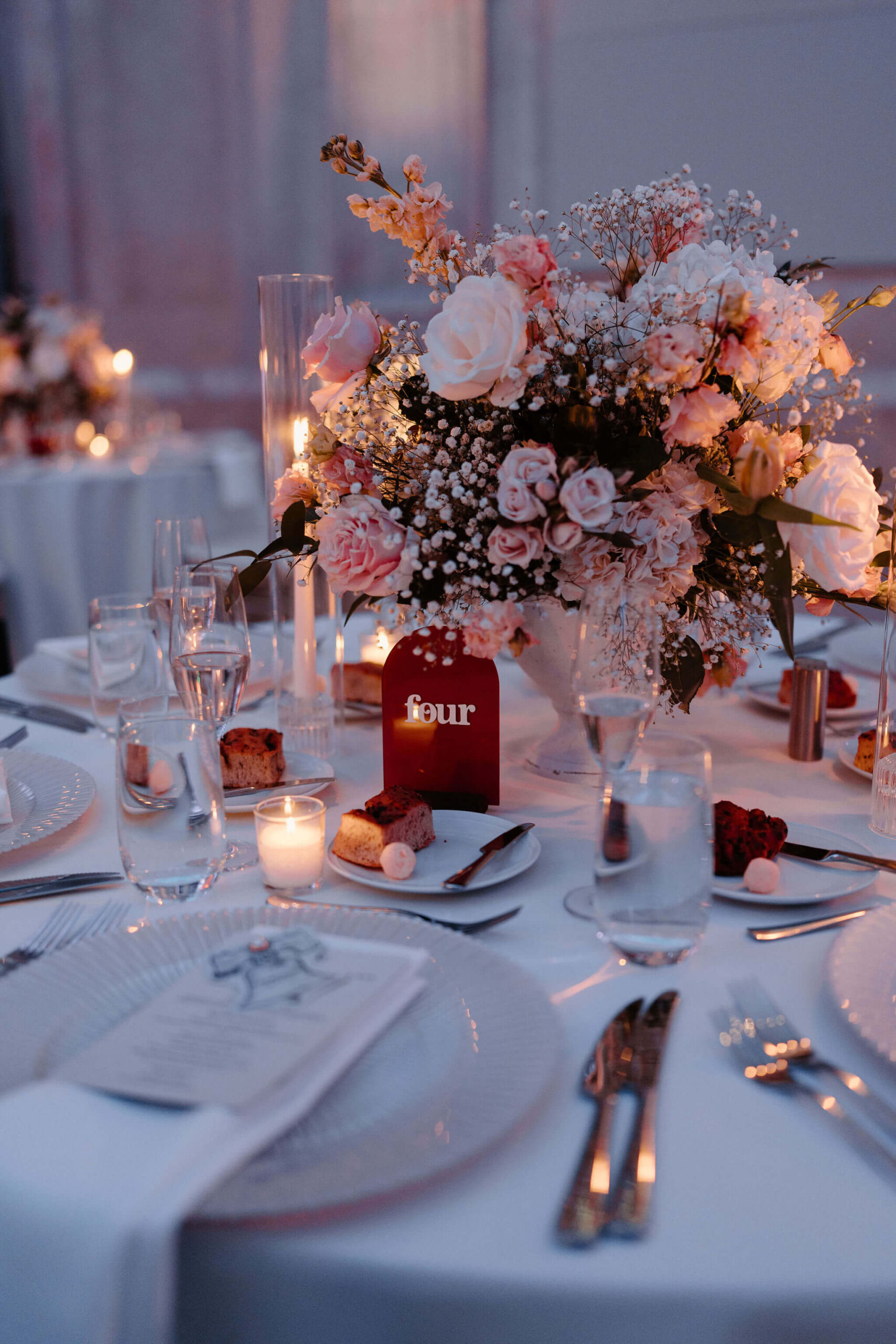 image of a rust-colored table number on a table at a wedding reception