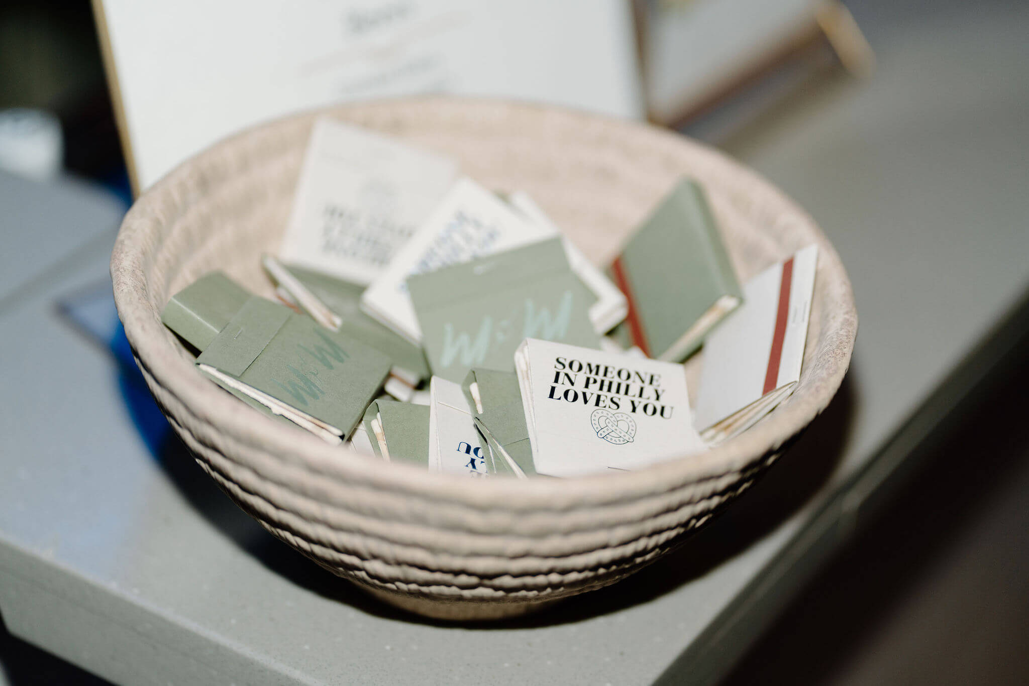 close up of green and white matchbooks that say "m&m" and "someone in Philly loves you"