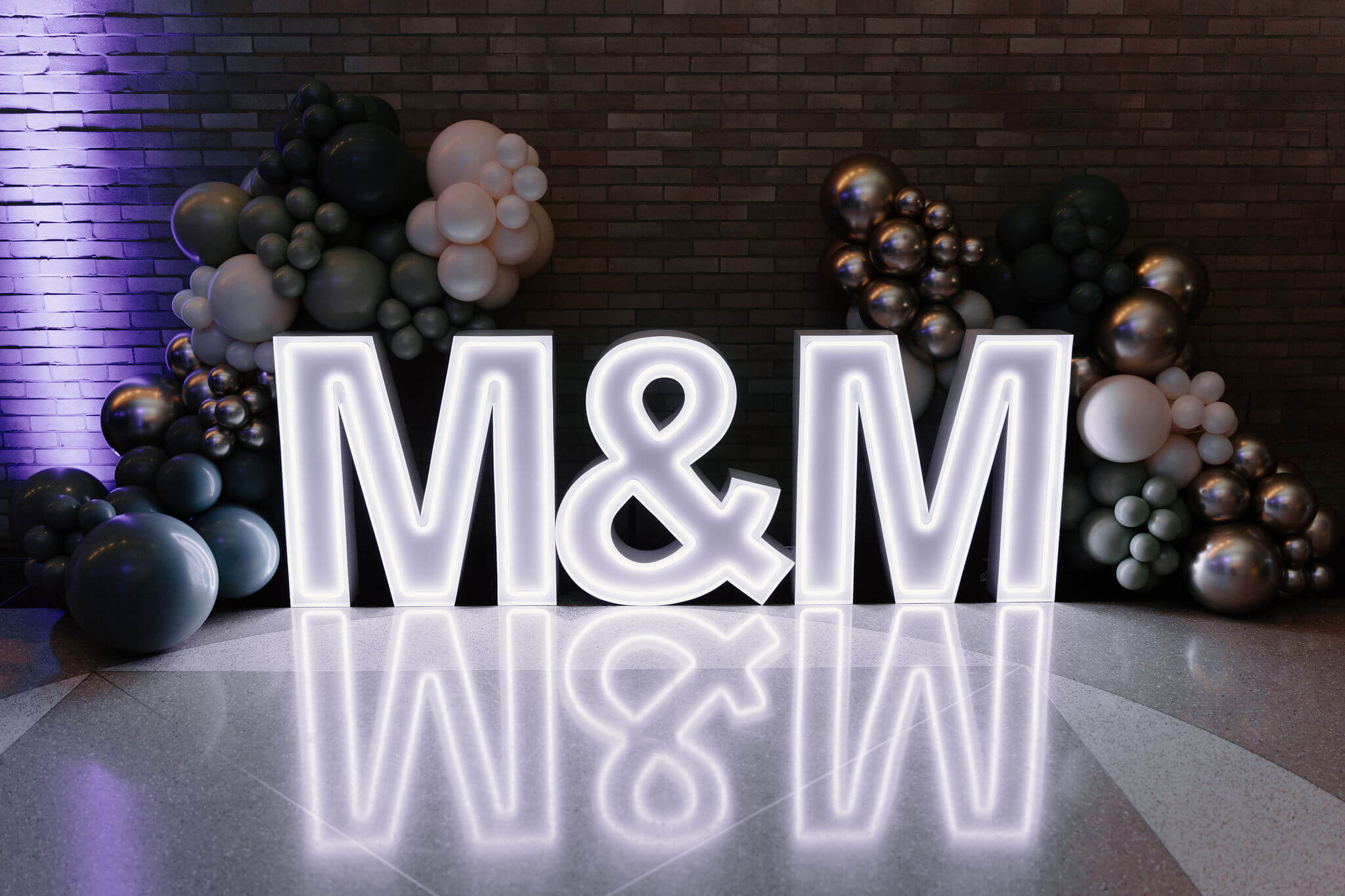 large white-neon letter sign of the letters "M&M" 