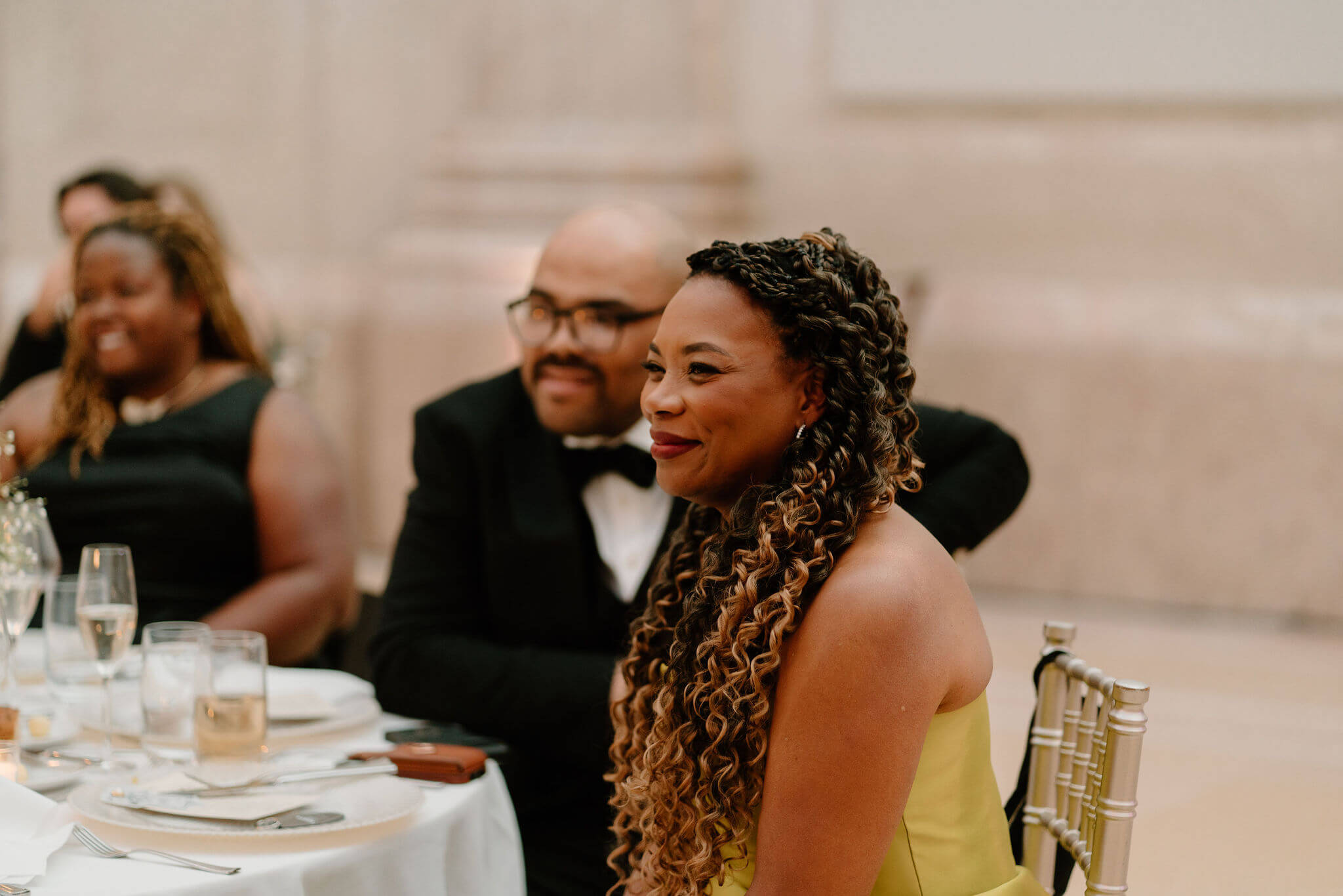 mother of the bride smiling during a speech at a wedding reception