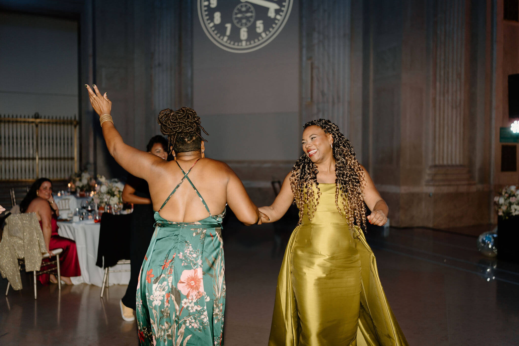 mother of the bride and a guest dancing and smiling during wedding reception