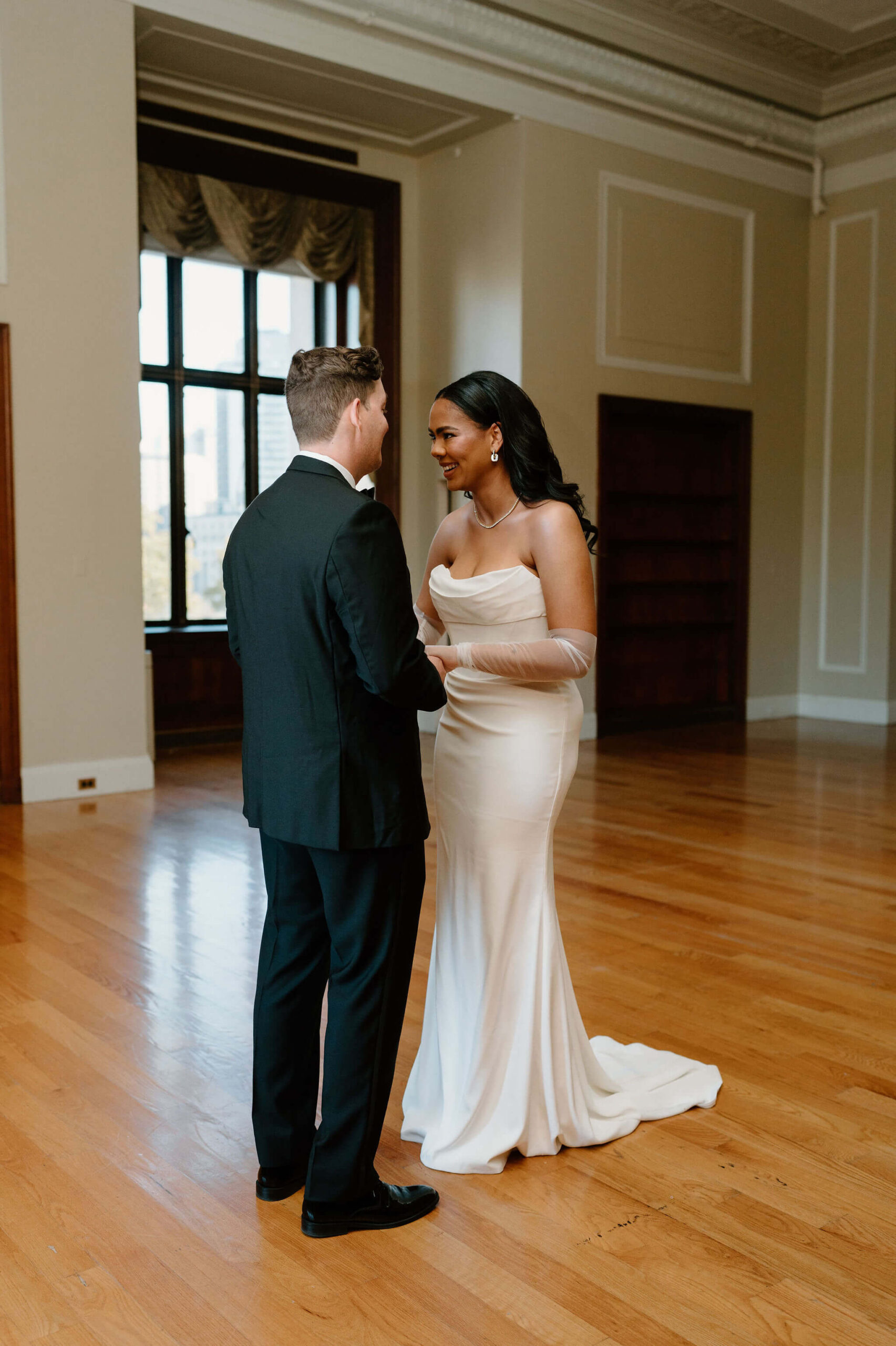 bride smiling widely at her groom after their first look at their franklin institute wedding