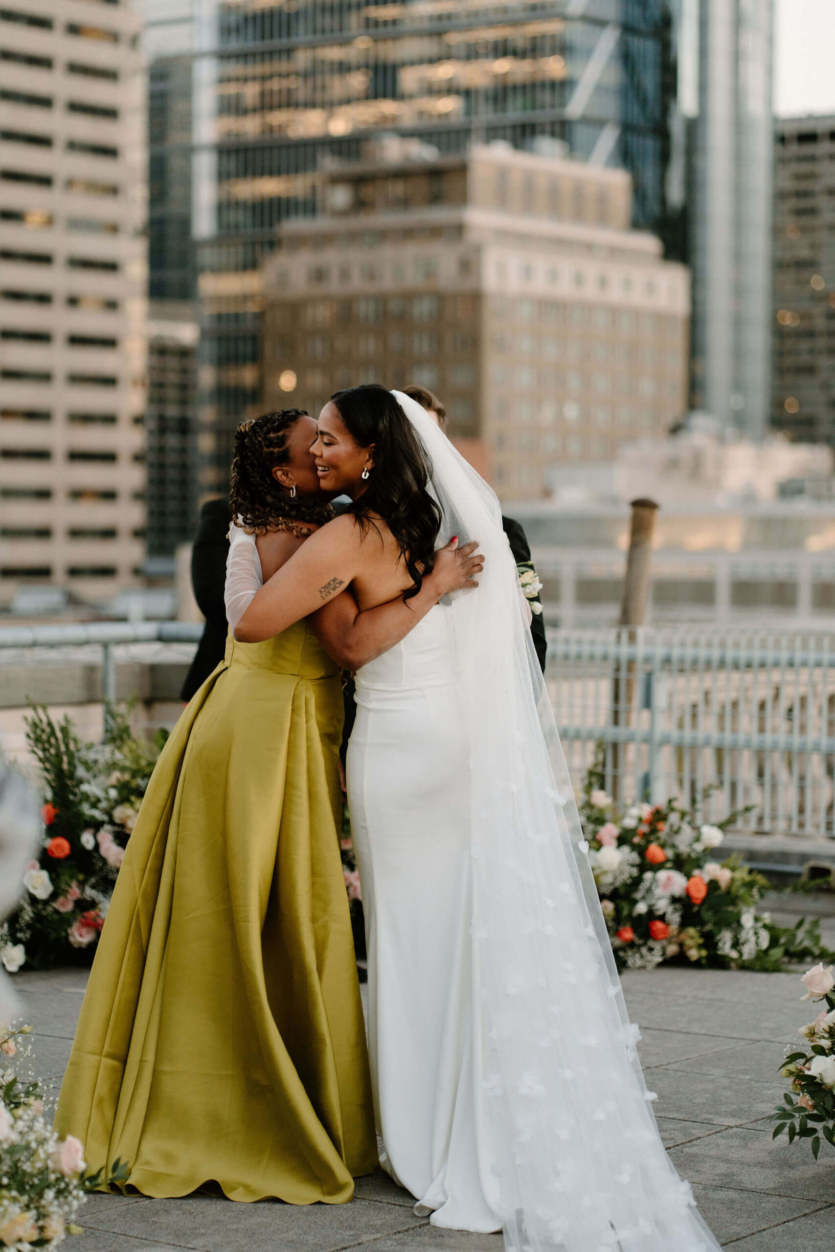 bride hugging her mother at the end of the aisle during wedding ceremony
