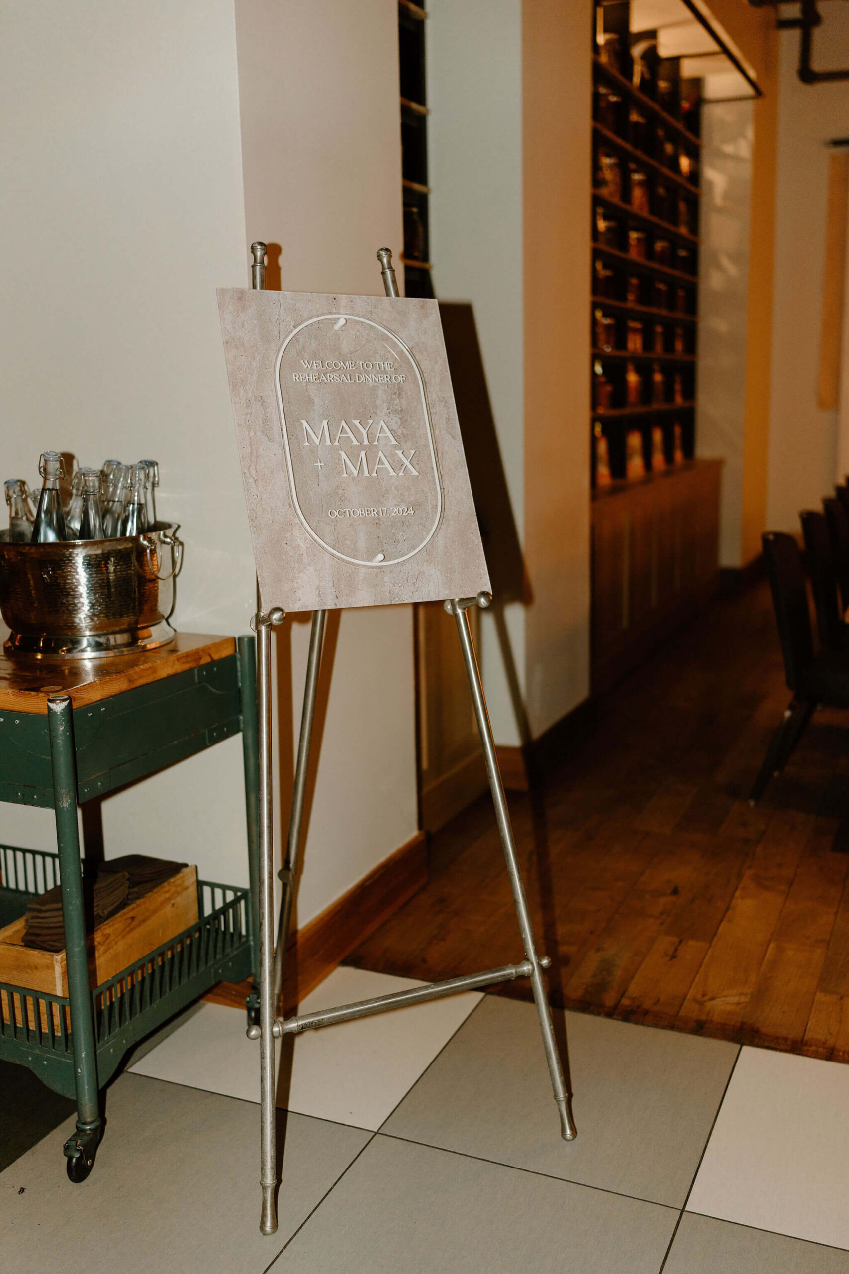 a pink marble welcome sign for Maya & Max's rehearsal dinner