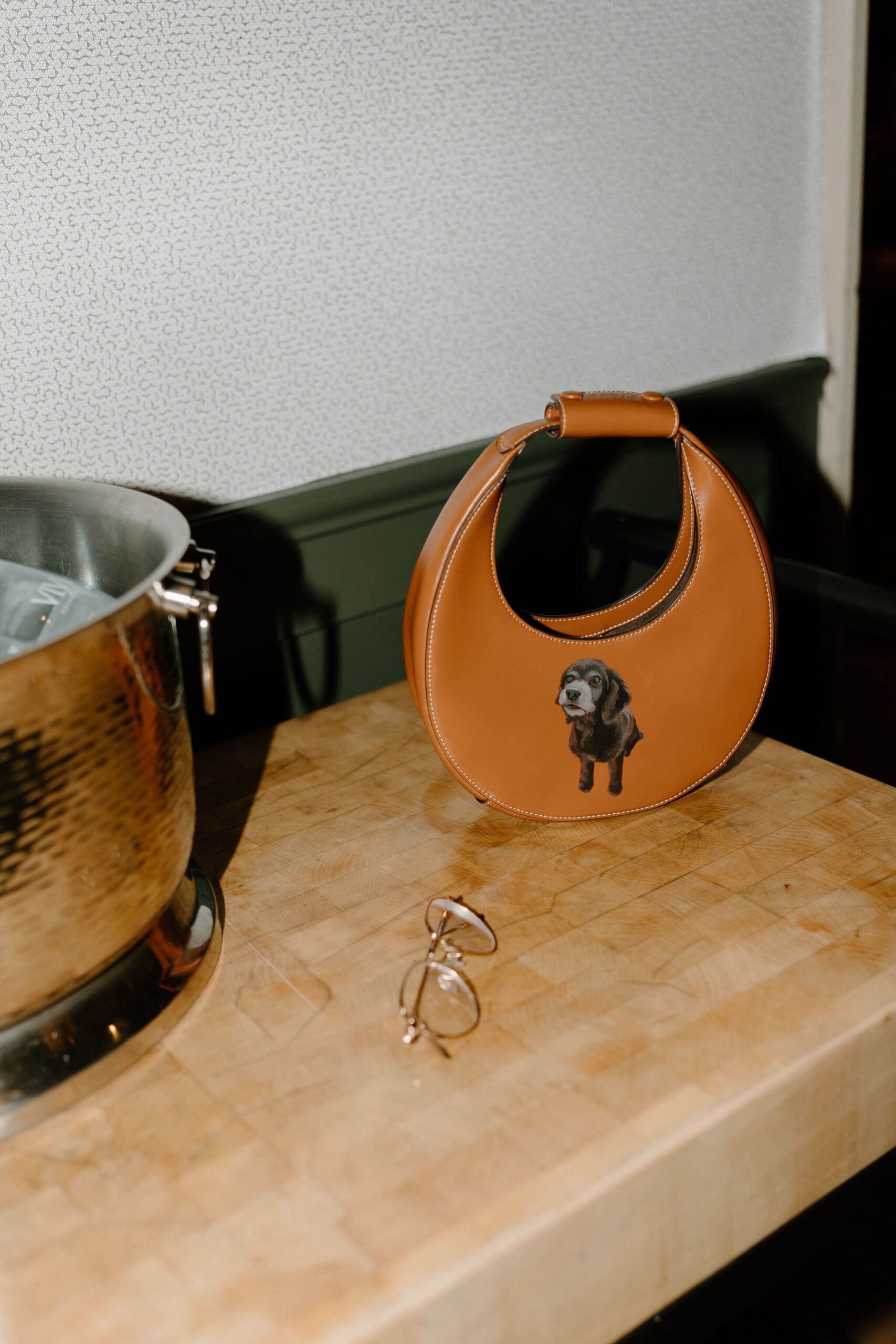brown leather bag with a screen-printed image of a dog