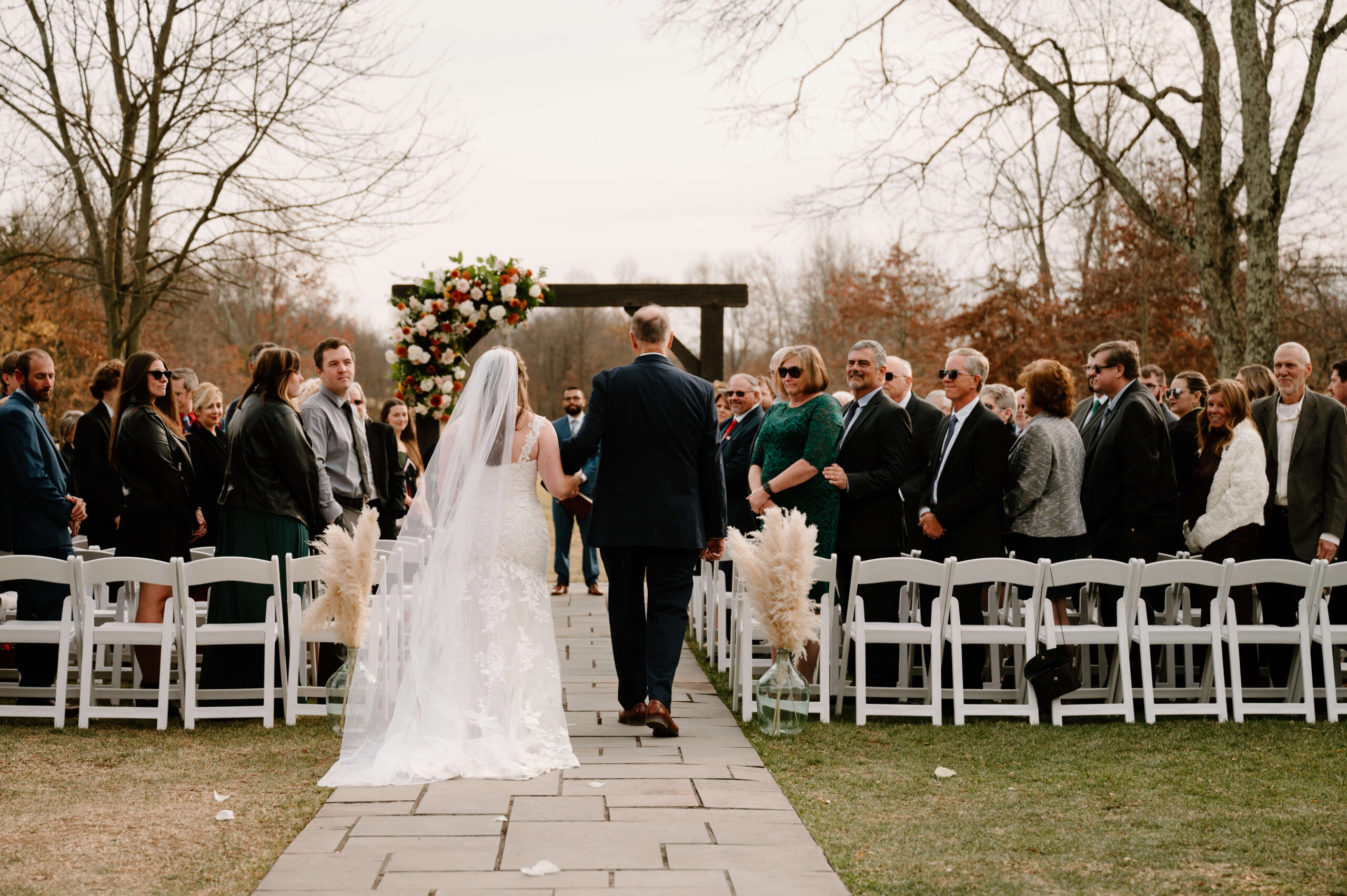 bride and her father walking down the aisle at her November wedding ceremony at the Farm Bakery and Events in Quakertown, PA