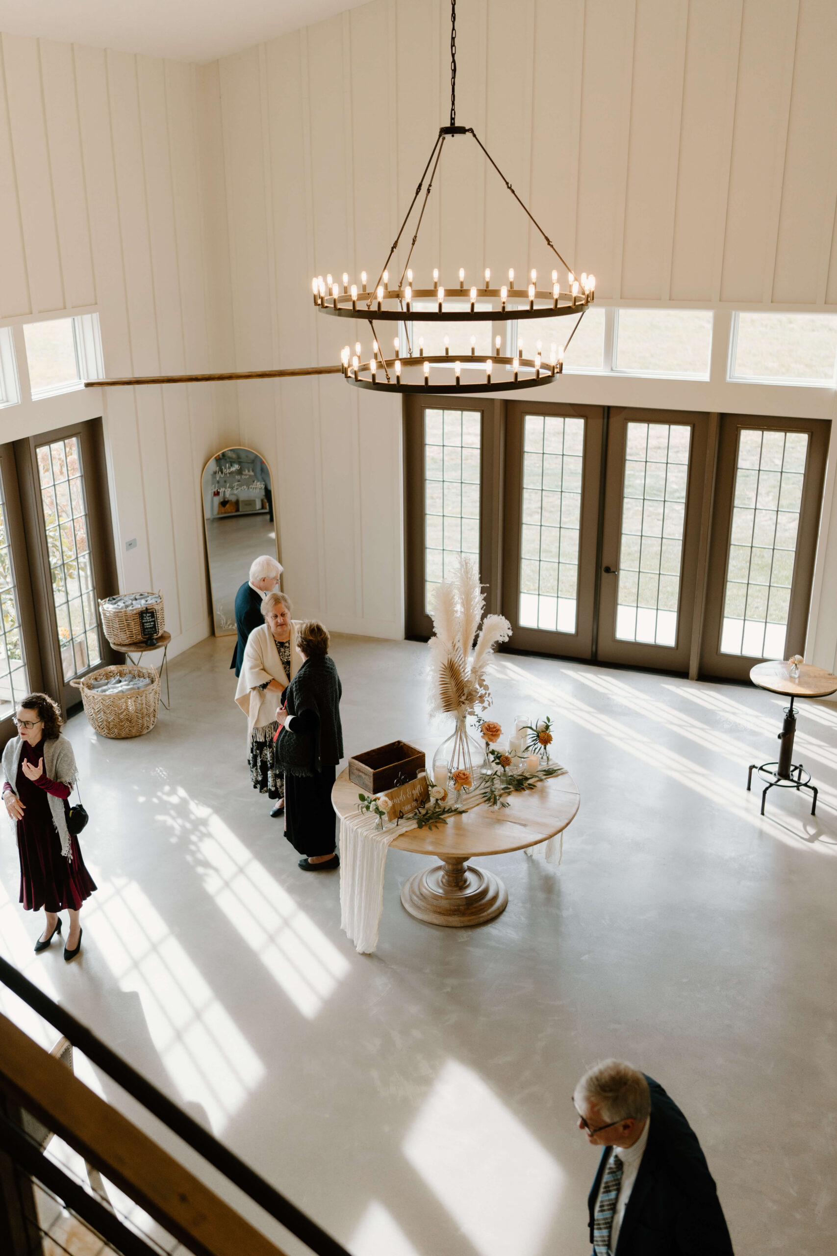 guests arriving for wedding ceremony, surrounding welcome table and card box