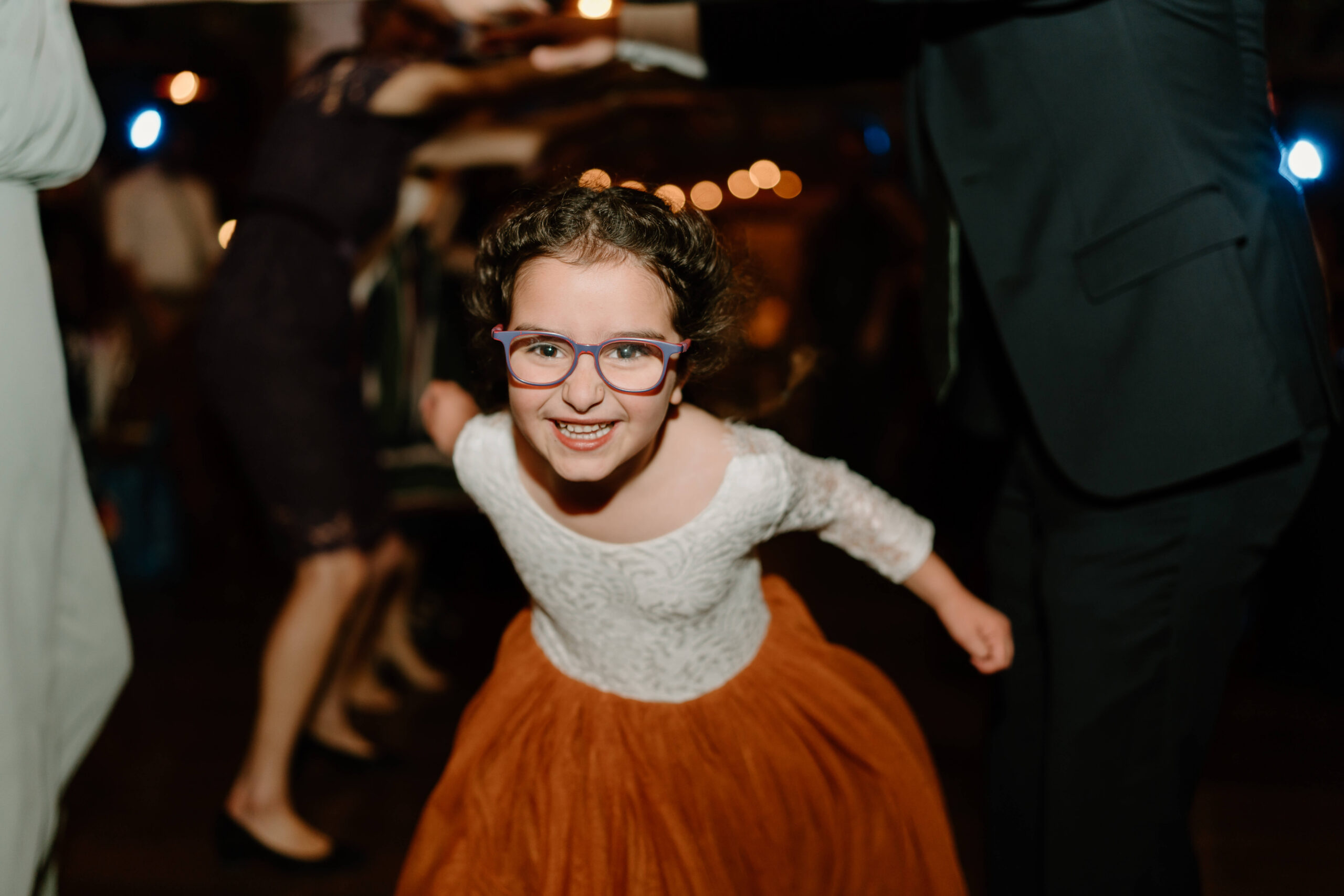niece of groom smiling widely during wedding reception