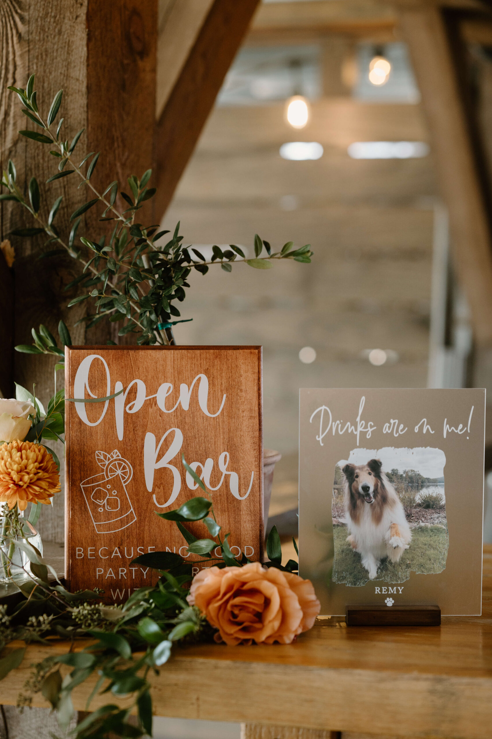 display of a sign reading "open bar" with a photo of the couples' dog, Remy, that reads "drinks on me!"