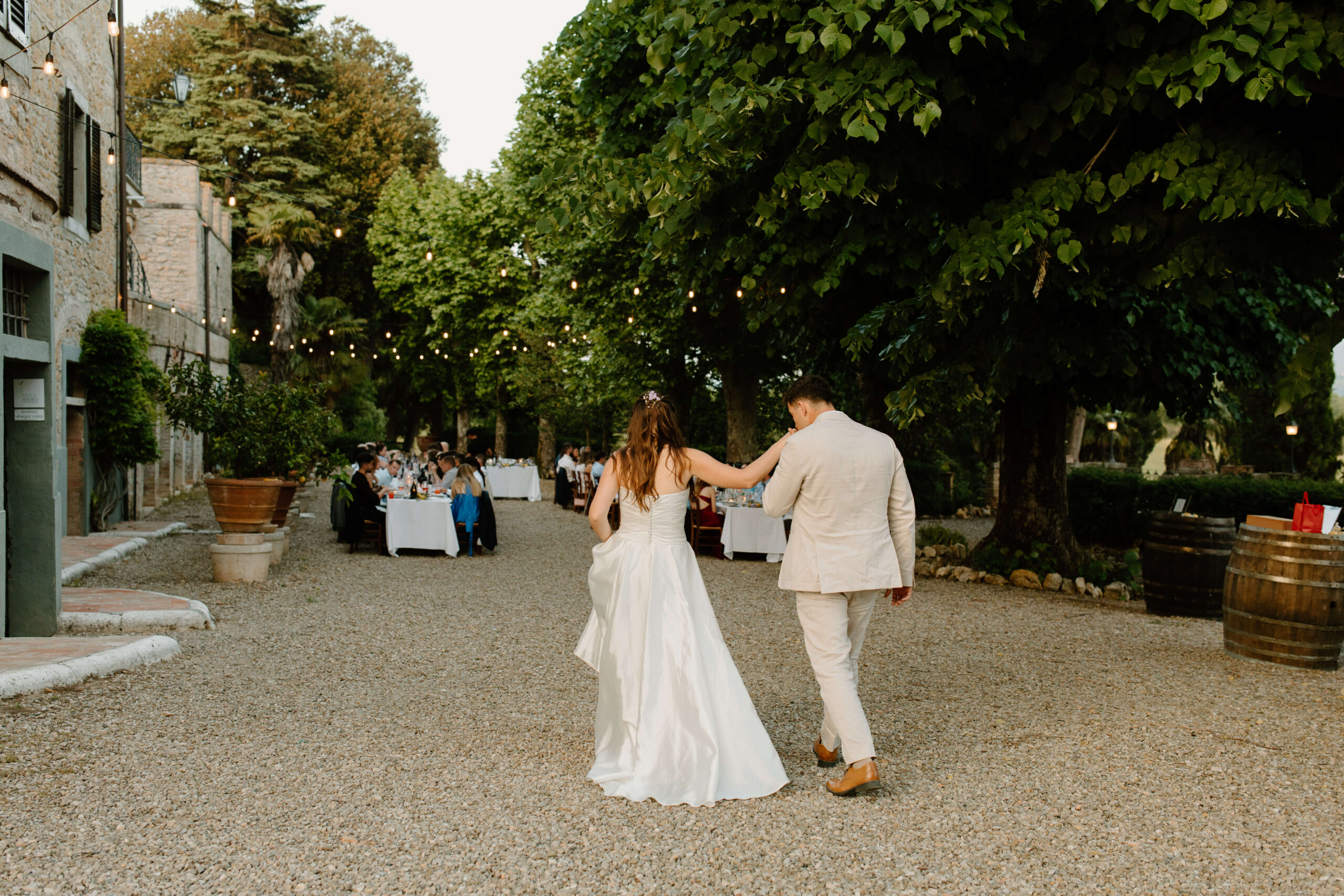 groom kissing bride's hand during wedding reception